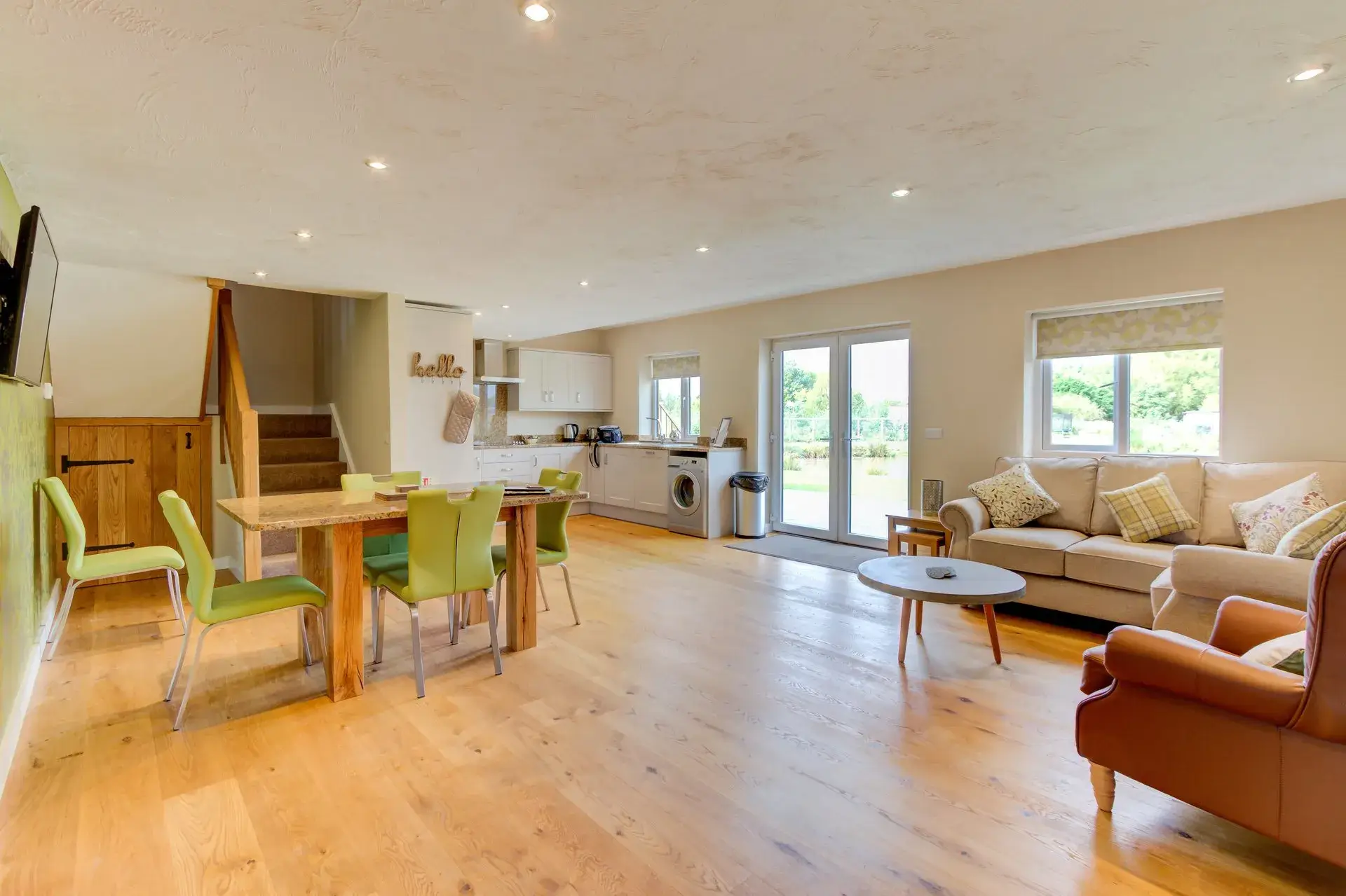 kitchen area with dining tables and chairs with patio doors